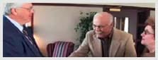 Douglas L. Carter meeting with two clients